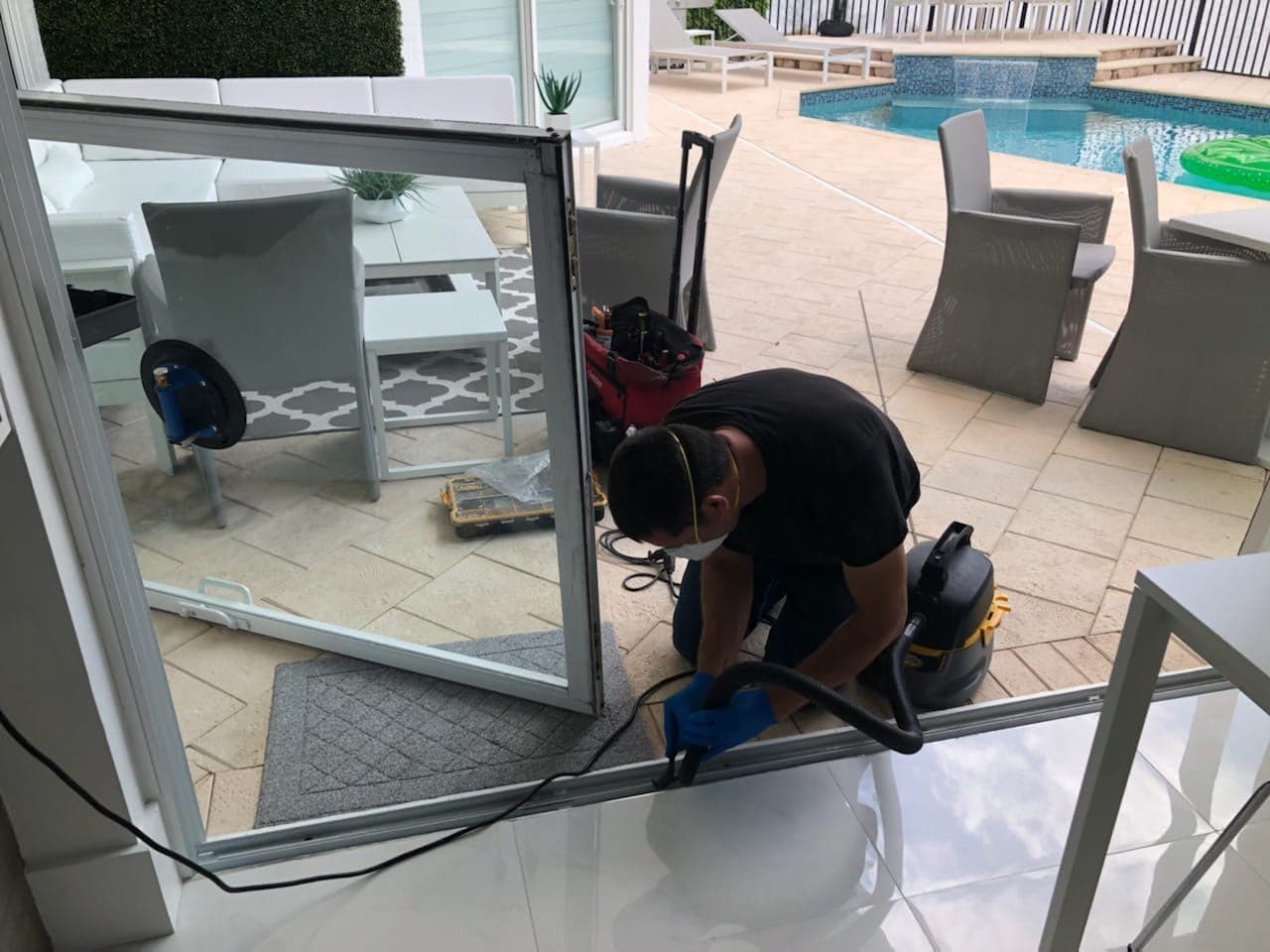 Technician clearing and restoring sliding door track channel in South Florida