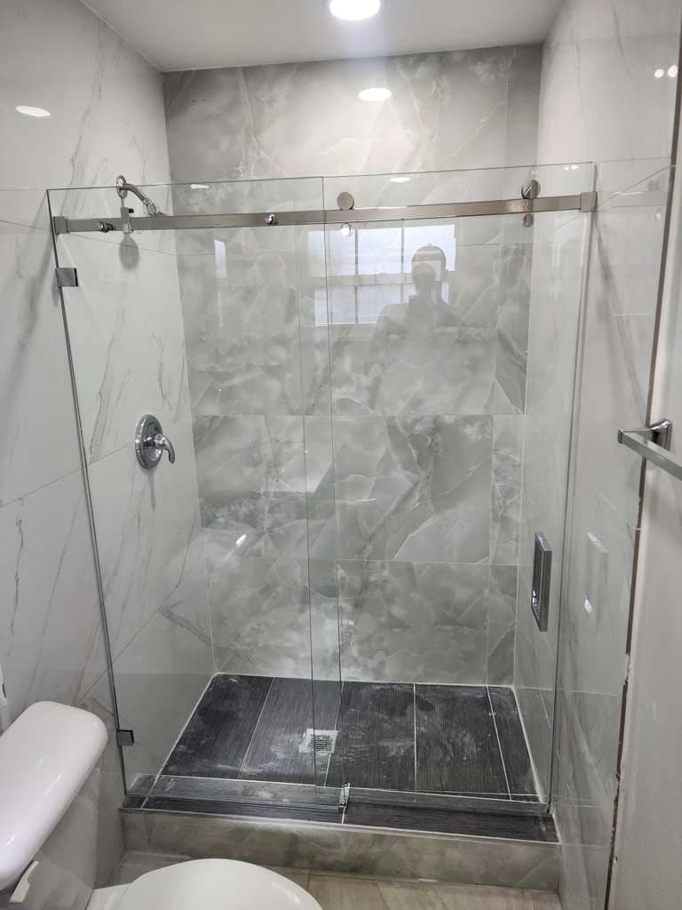 Frameless shower door adjustment
